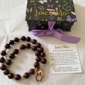 Jane Win brown wooden bead and gold necklace.